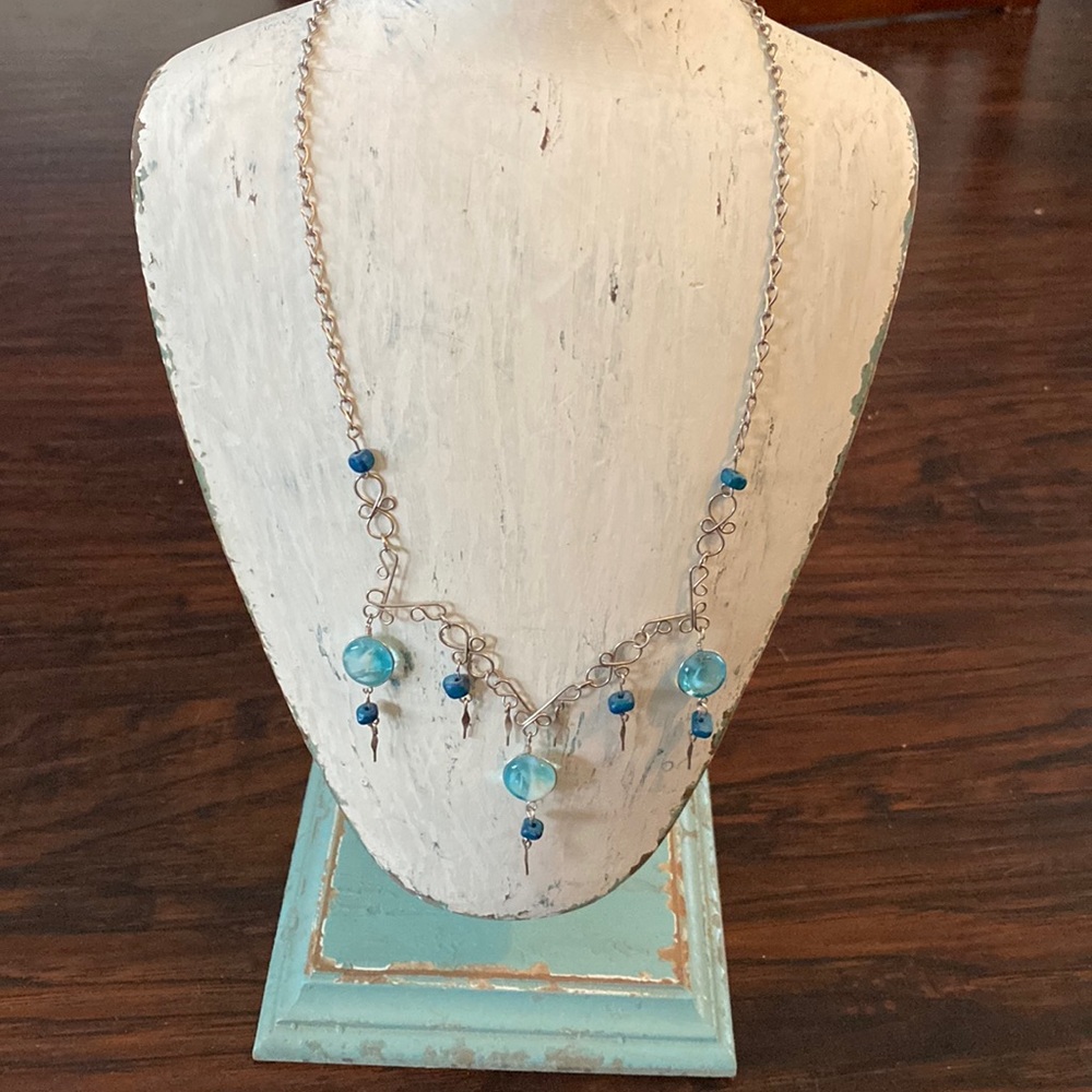 Very delicate ladies necklace. Silver color with blue stones and beads.